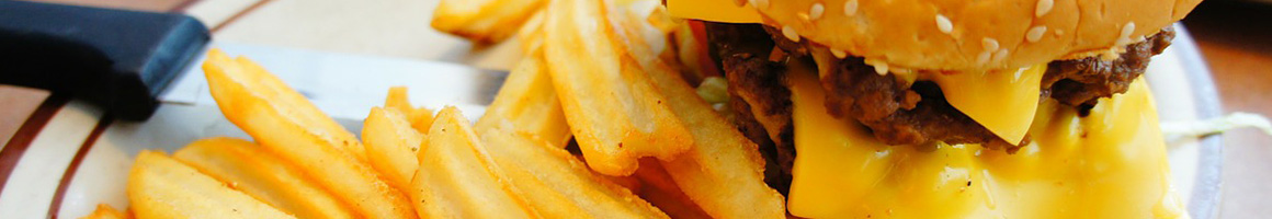 Eating American (Traditional) Burger Greek Hot Dog at Heros Subs & Burgers restaurant in Tulsa, OK.